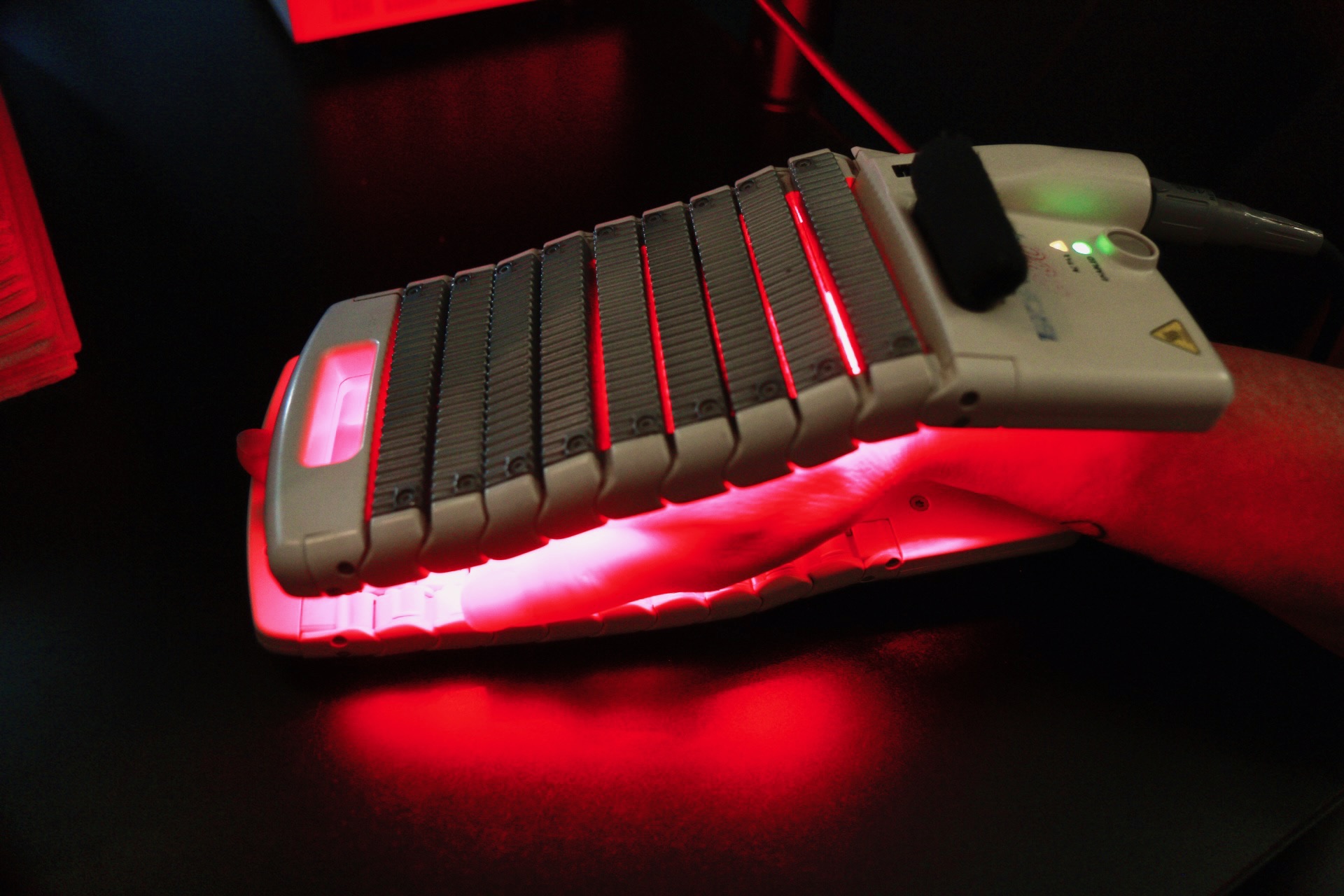 Cold laser therapy device treating a patient's hand