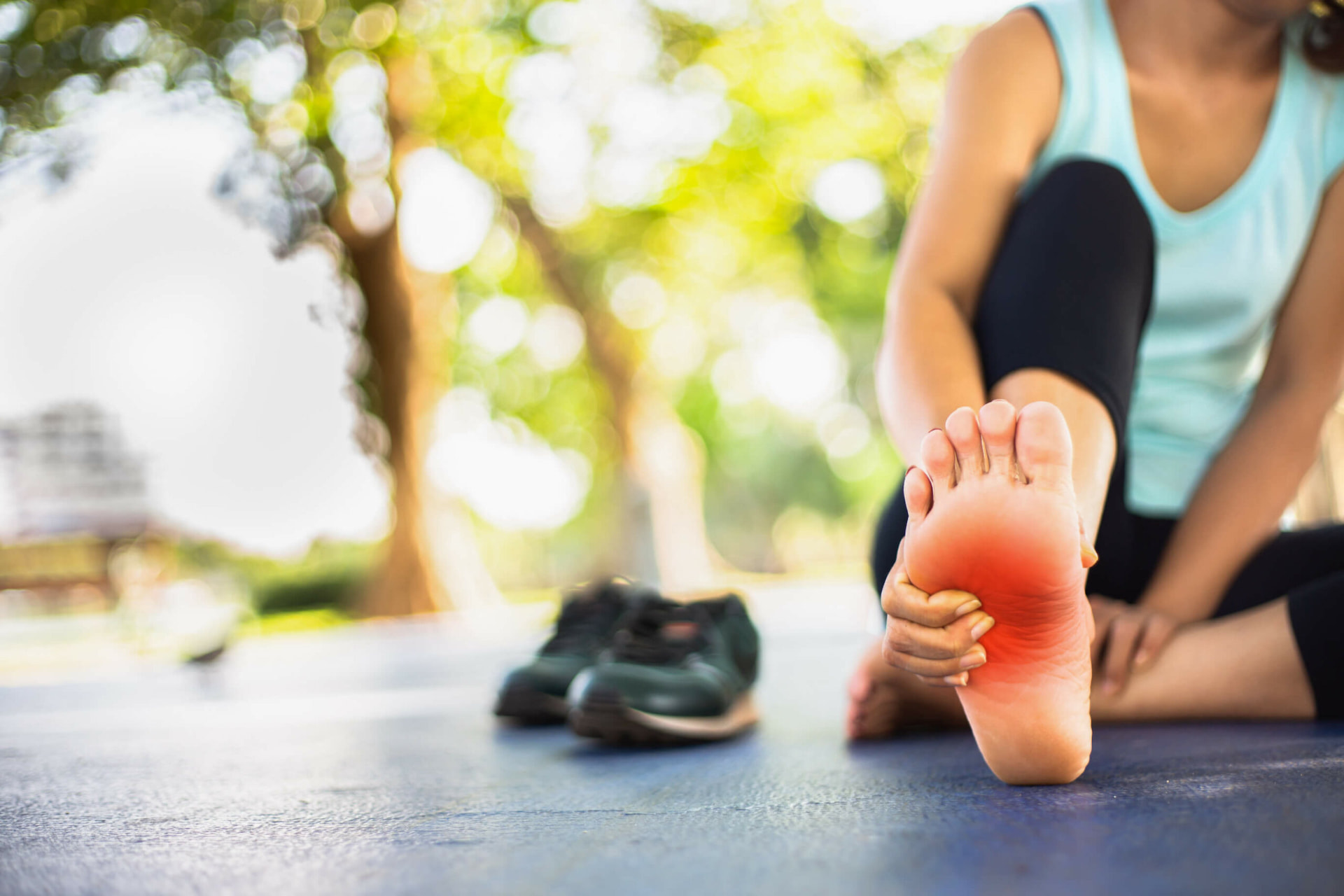 Person holding their foot in pain from peripheral neuropathy